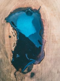 High angle view of water fallen on wooden table