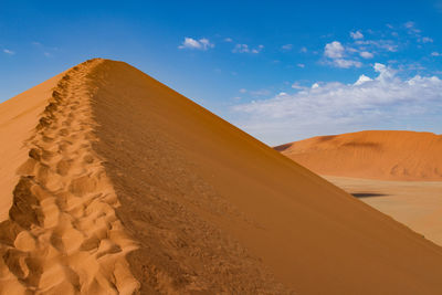 Sand dune against sky