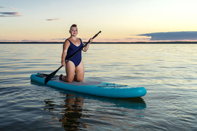 Man kayaking in sea