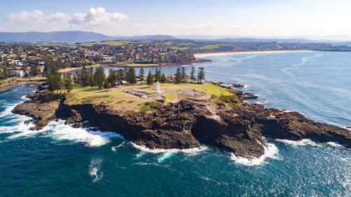 High angle view of rocks in sea against sky