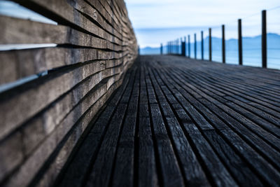 Close-up of boardwalk against sky