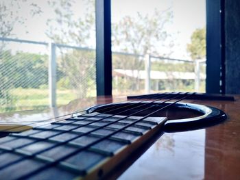 Close-up of guitar on table