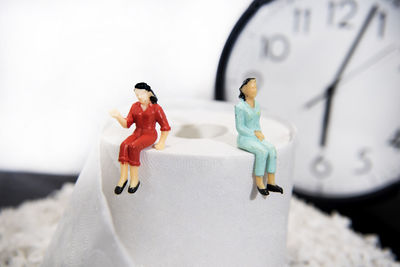 Close-up of figurine with toys against blurred background