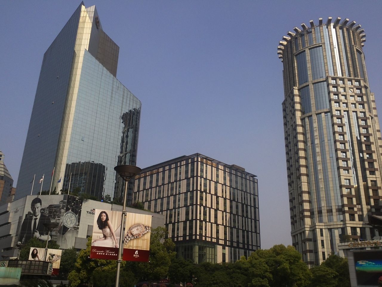 building exterior, architecture, built structure, tower, low angle view, clear sky, tall - high, city, skyscraper, famous place, blue, travel destinations, modern, capital cities, travel, international landmark, tourism, office building, tree, day