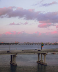 Pier over sea against sky during sunset