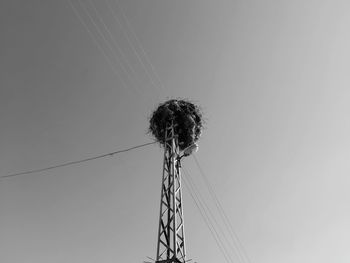 Low angle view of electricity pylon against sky