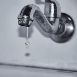 Close-up of water dripping from faucet in bathroom