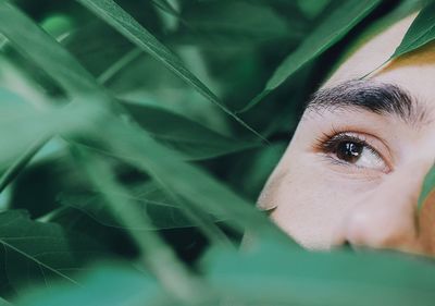 Close-up of young man by plants