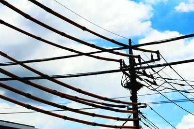 Low angle view of electricity pylon against sky