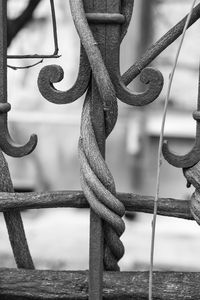 Close-up of rope tied to metal fence