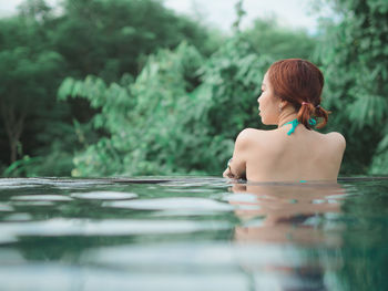 Rear view of woman in swimming pool