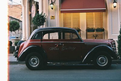 Car parked on street against building in city
