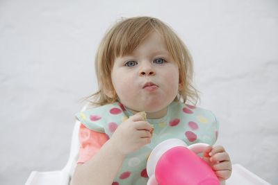 Portrait of cute girl holding pink flower