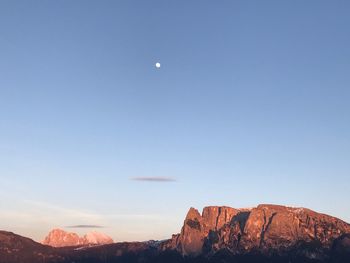 Scenic view of mountains against blue sky