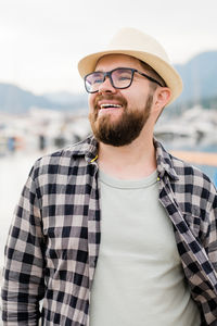 Portrait of young man standing against sea