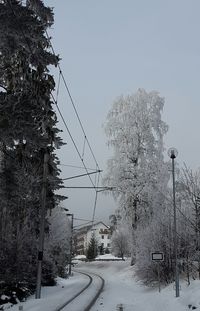 Snow covered street against sky