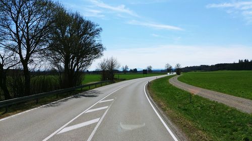 Empty road along countryside landscape