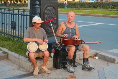 Side view of man playing drum