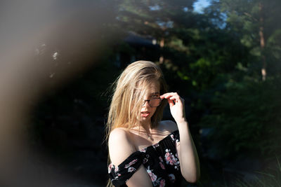 Portrait of young woman standing outdoors