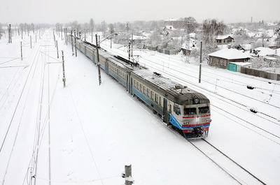 High angle view of train on snow covered railroad tracks