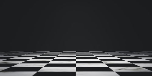 Close-up of tiled floor against black background