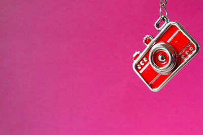 High angle view of key hanging on pink background