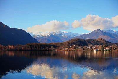 Scenic view of lake by mountains against sky