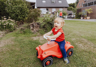 Boy with toy car on grass