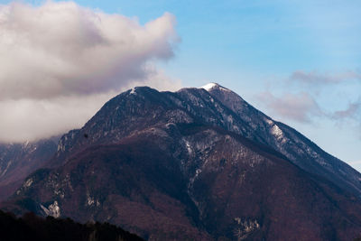 Low angle view of storm clouds over mountain