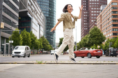 Side view of woman standing on street