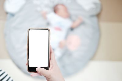 Midsection of man using mobile phone