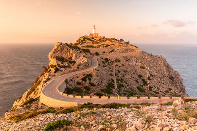 Cape formentor lighthouse in mallorca with the reddish tones of sunset