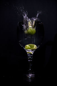 Close-up of wine glass against black background