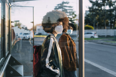 Woman standing on street in city