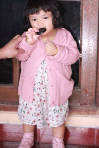 Full length of a girl eating food