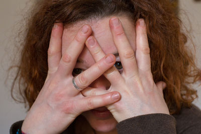 Portrait of woman covering face