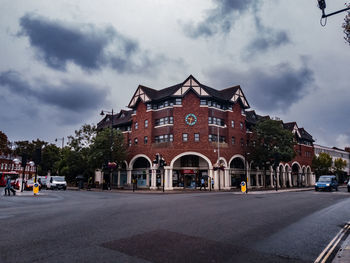 Road by building against sky