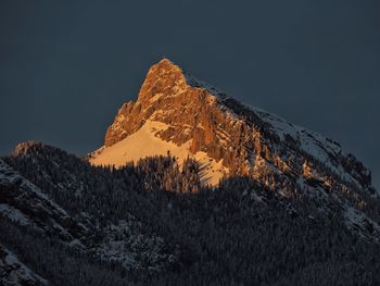 Low angle view of snowcapped mountain against sky