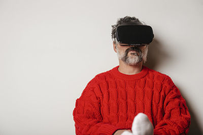 Vr glasses with virtual reality seen by the man sitting at home.