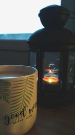 Close-up of illuminated tea light candles on table