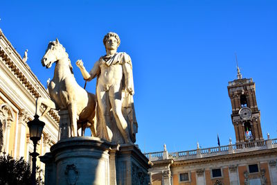 Low angle view of statue against blue sky