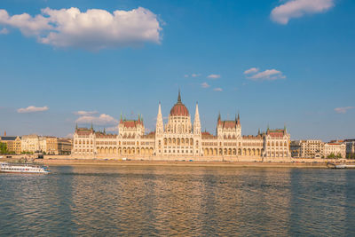 Historical buildings at waterfront during sunset