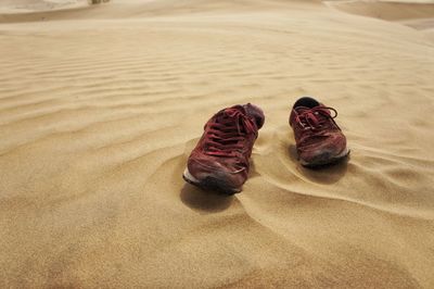 Abandoned shoes on sand