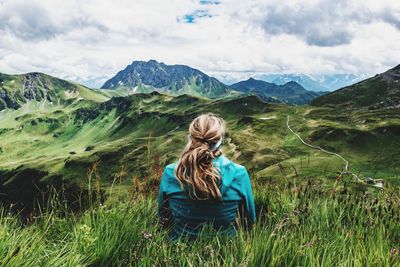 Rear view of woman in mountains against sky