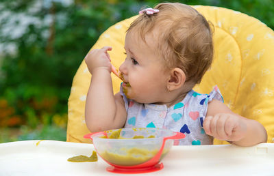 Cute girl looking away while eating food