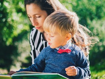 Mother sitting with son outdoors