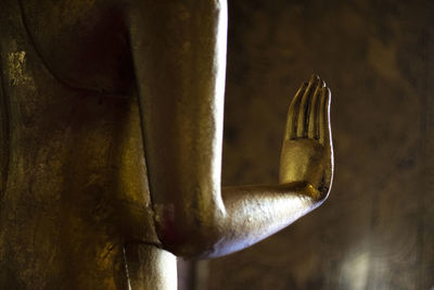 Close-up of a buddha statue against wall