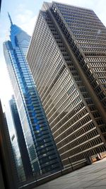 Low angle view of modern buildings against sky in city