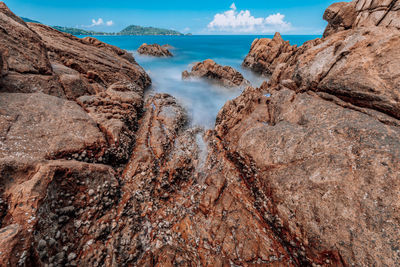 Panoramic shot of rocks on beach against sky