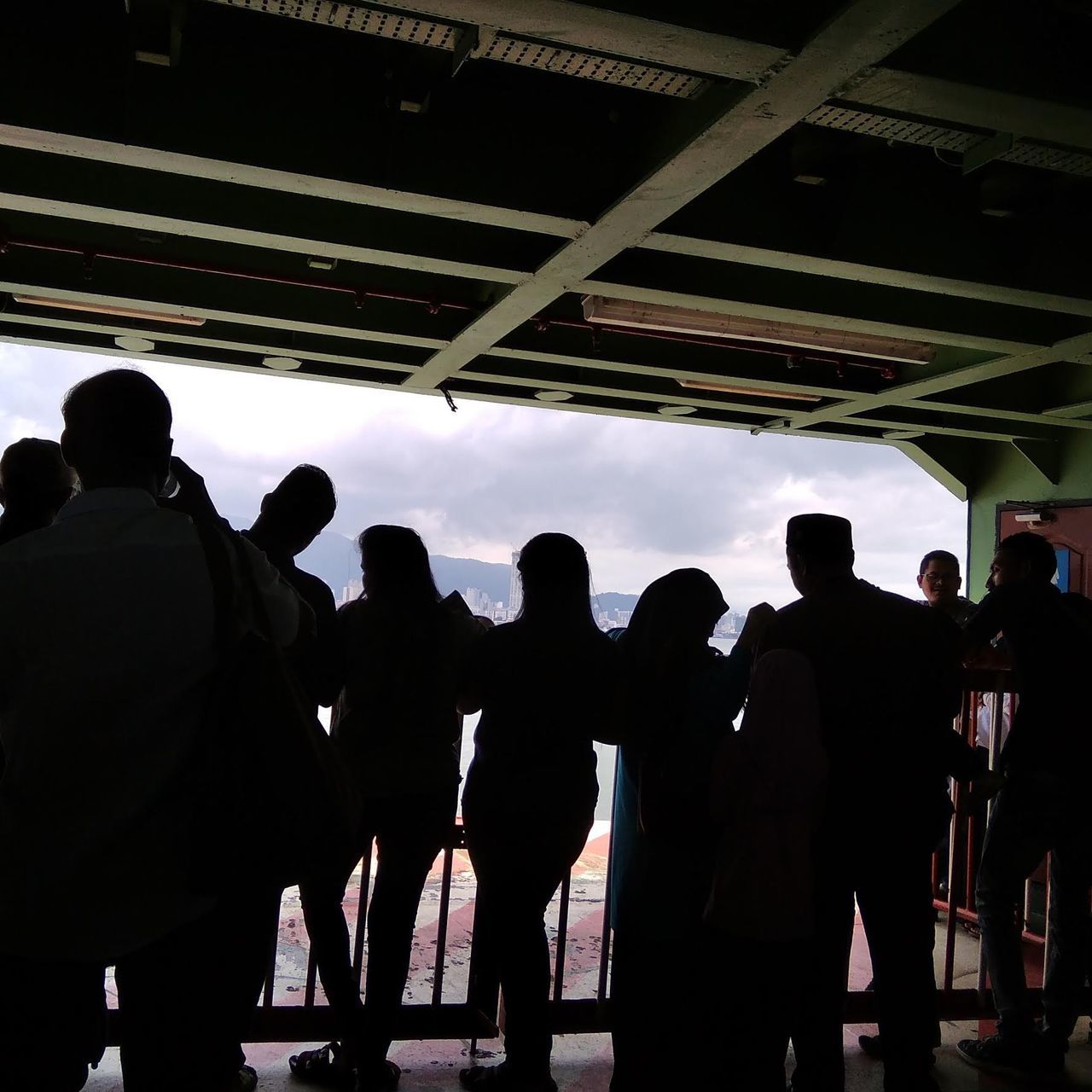 group of people, real people, men, silhouette, lifestyles, crowd, people, women, indoors, standing, leisure activity, architecture, adult, transportation, built structure, day, group, enjoyment, waiting, ceiling